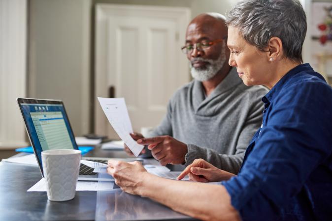 Man and woman budgeting at computer