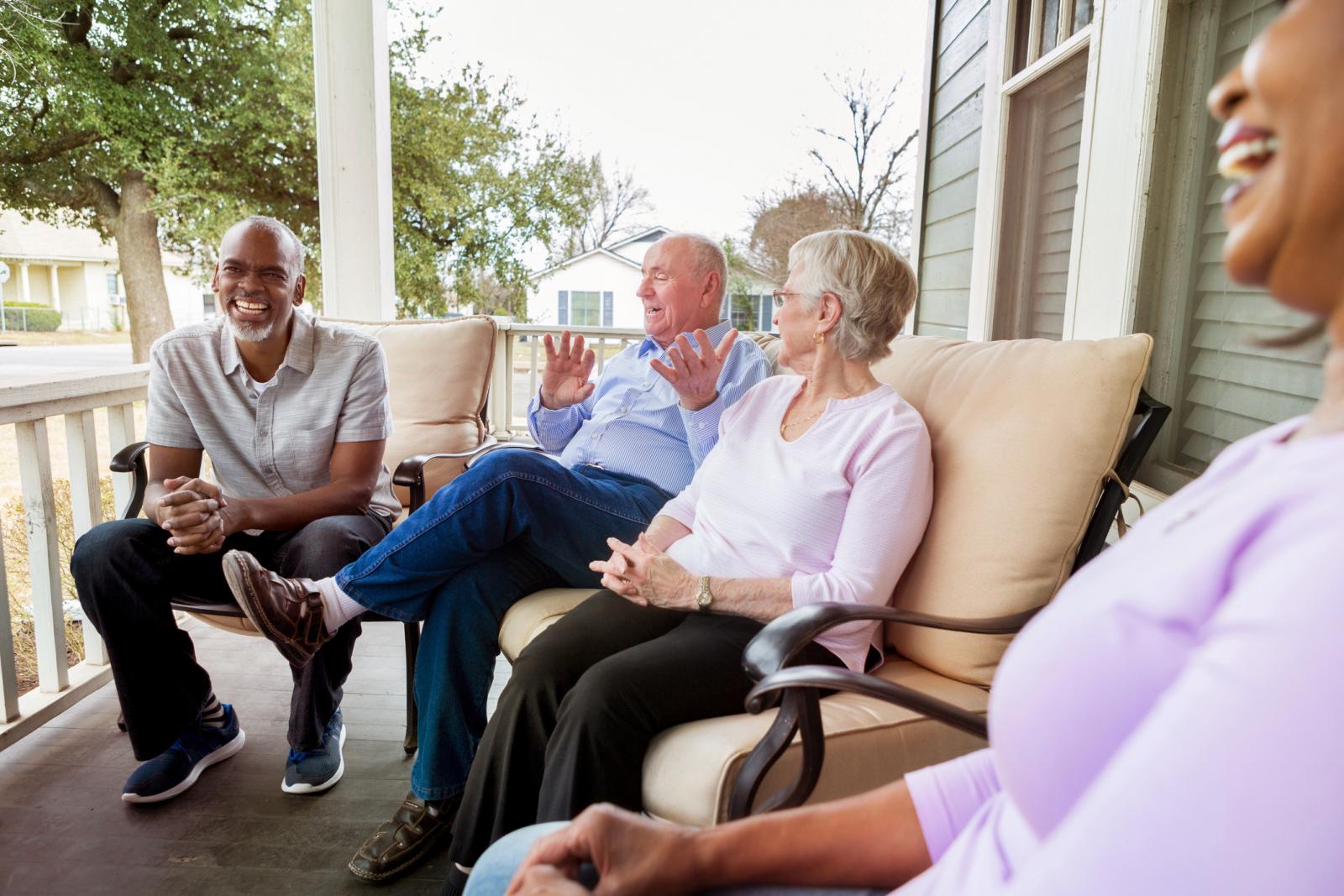 Seniors on porch chatting together