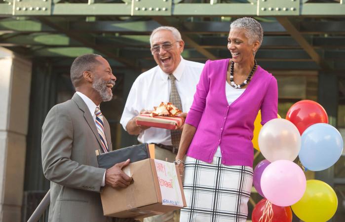 Co-workers celebrating with retiring man