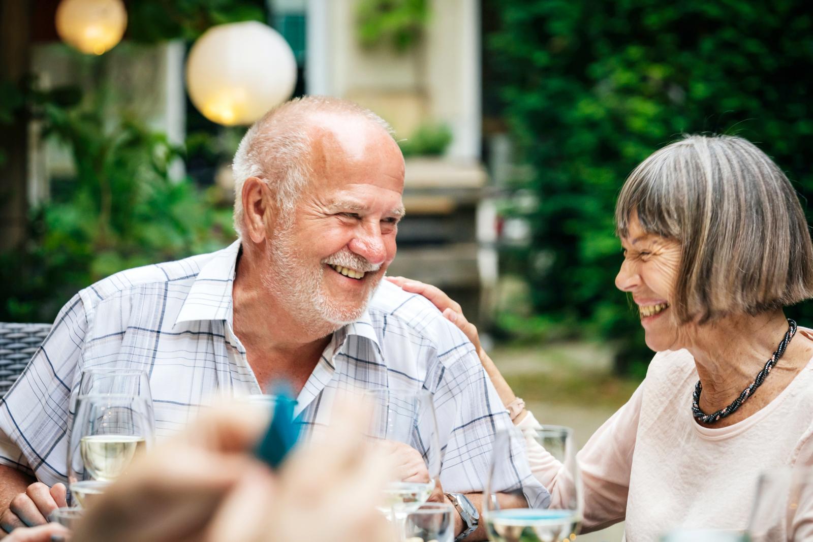 Elderly Couple Smiling At Family BBQ