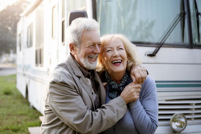 Couple standing in front of RV