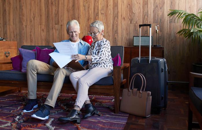 Mature couple looking through check-in clip board