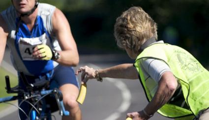 Image of a senior woman volunteering at a cycling event