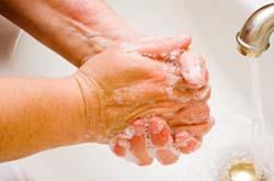 Nursing home worker washing her hands