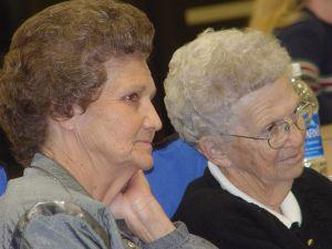 Two senior women attending a group discussion