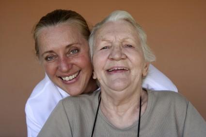 Caregiver helping an elderly woman affected by dementia