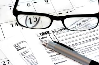 Glasses, tax form, and pen