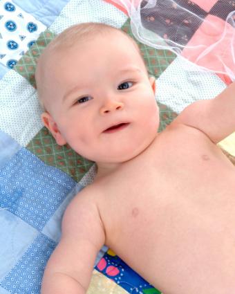 Baby on a quilt; Copyright Cynthi Kovach at Dreamstime.com