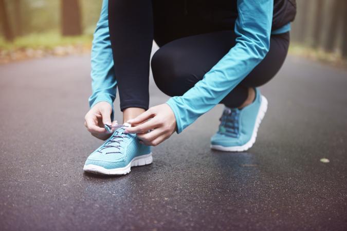 woman tying sneaker