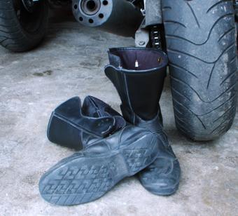 Motorcycle boots next to a tire