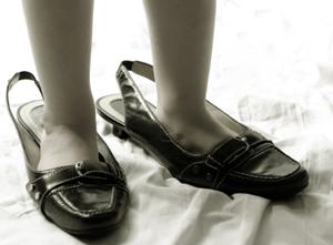 Feet in shoes many sizes too large