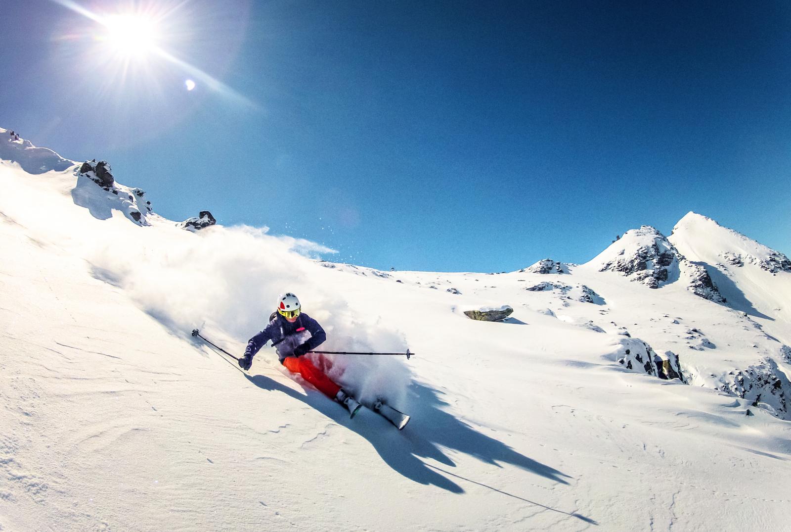 Skier doing turn in fresh powder snow