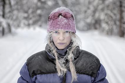 Blue-lipped woman outside in winter
