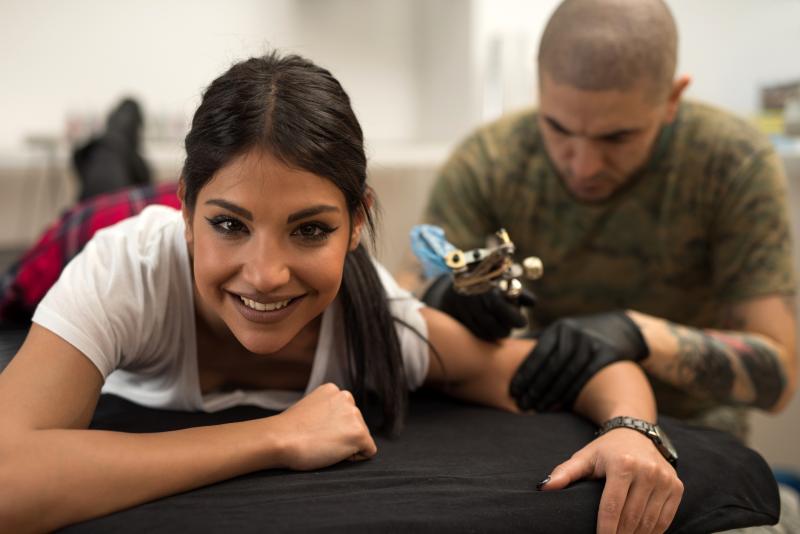 Woman getting a tattoo