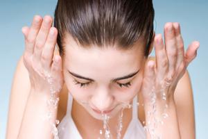 woman cleansing her face