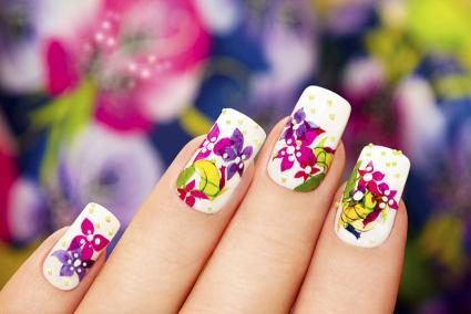 Bright floral nail art with small gold pearls