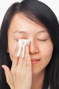 Woman Cleansing Face