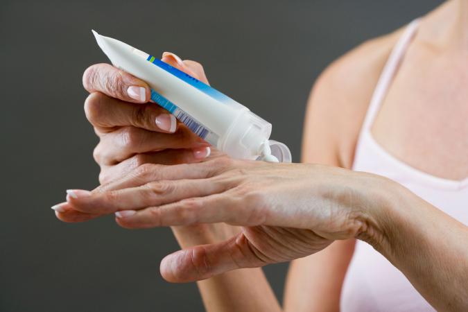 Woman applying hand cream