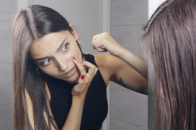woman finding acne on face