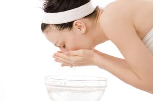 Woman cleansing her skin