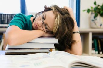 High school student sleeping in library