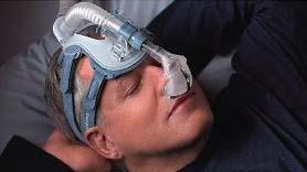 Peaceful sleep with a CPAP machine and mask.