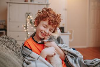 Boy Playing with Pet Ferret