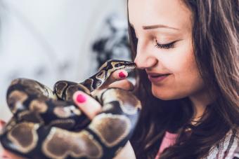 young woman holding snake