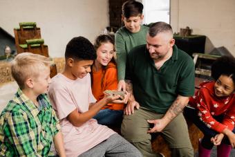 Teenage Boy Holding a Reptile