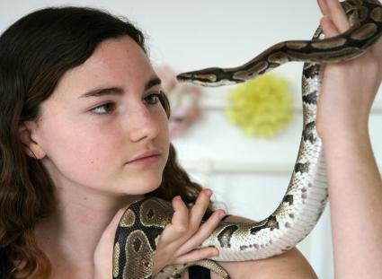 Girl holding a ball python