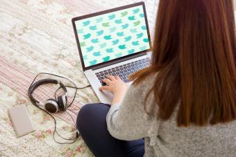 Girl using her laptop in bed
