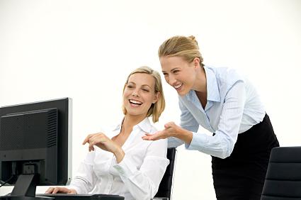 Businesswomen using social networking at work.