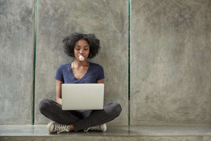 Girl seated using laptop