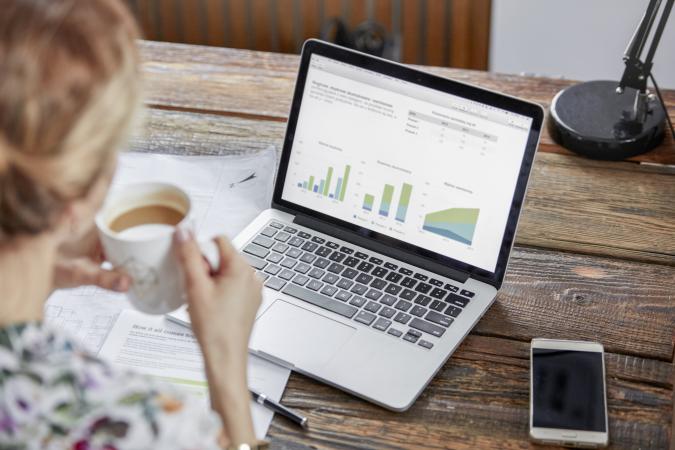 Businesswoman reviewing data on laptop