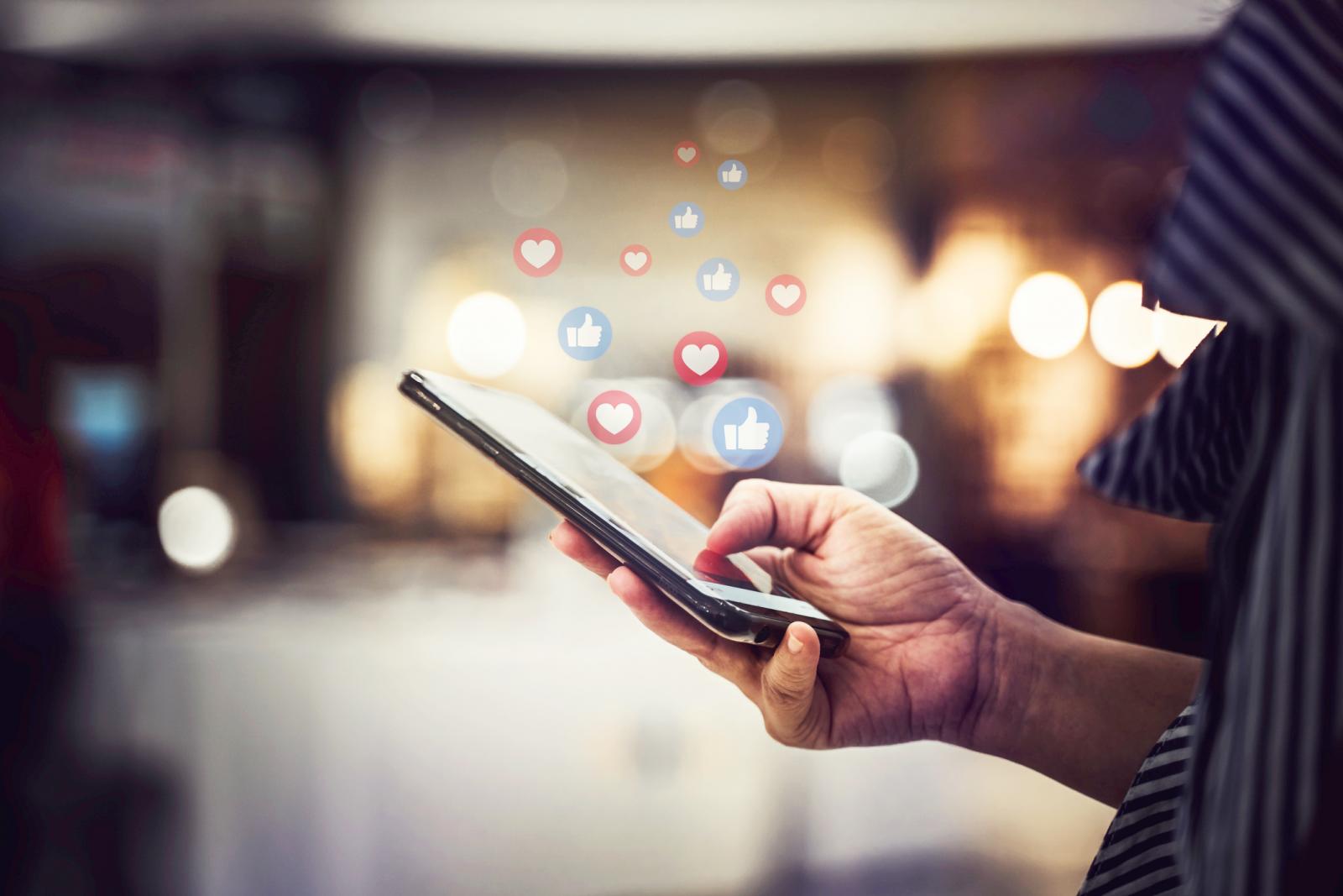 Hand using smartphone with Social media concept