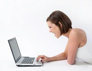 Woman using social media and laughing