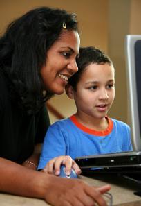 Teacher helping student at the computer