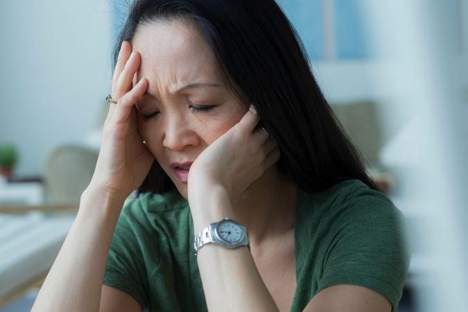 Stress woman with head in hands