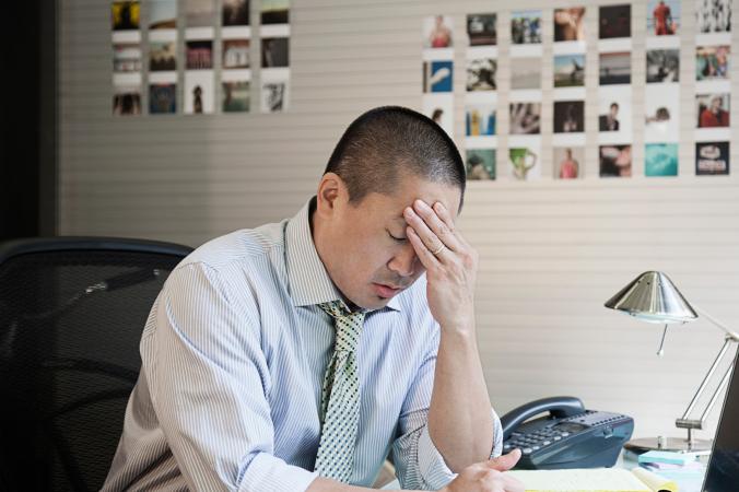 Stressed man sitting at desk