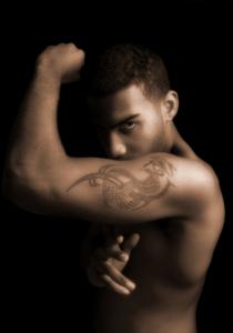 Man doing karate with dragon tattoo