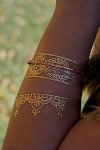 Metallic temporary tattoo on arm