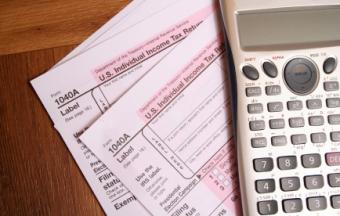Two tax forms with calculator