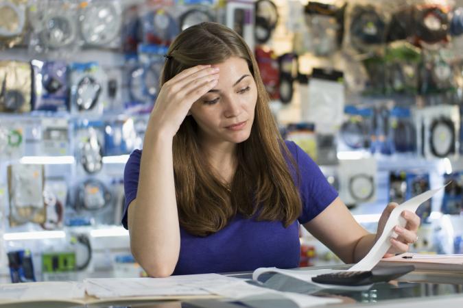 Woman Checking Bills And Invoices