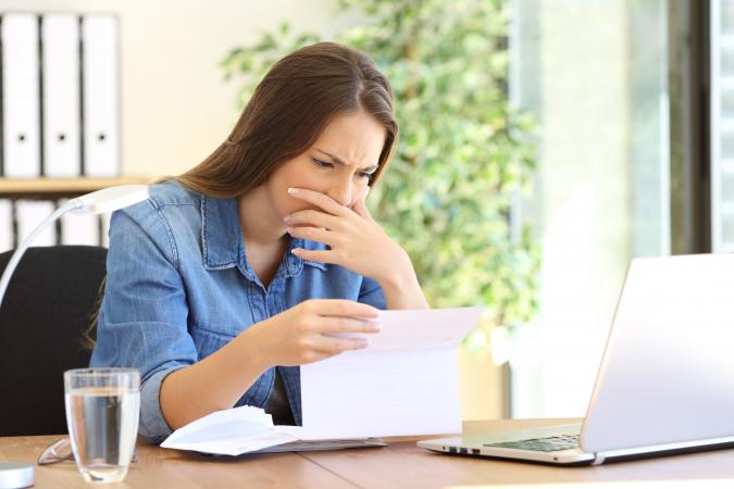 Worried girl reading a letter