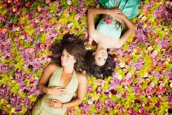 Women lying on grass with flowers