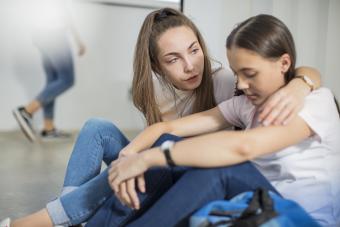 Teen girl consoling a sad friend