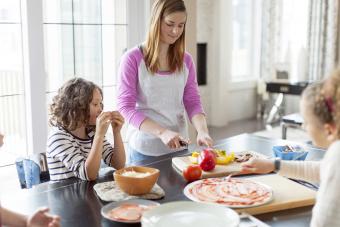 Babysitter chopping peppers for pizza