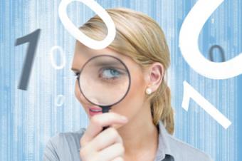 Woman studying numbers with magnifying glass