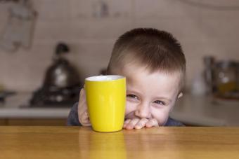 Boy holding mug in the kitchen