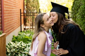 Teenage girl graduation from primary school portrait in backyard